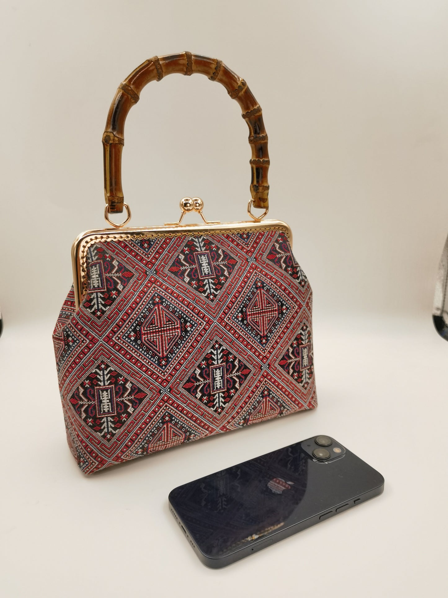 Guangxi Zhuang Brocade Handbag with Gold-Trimmed Bamboo Handle